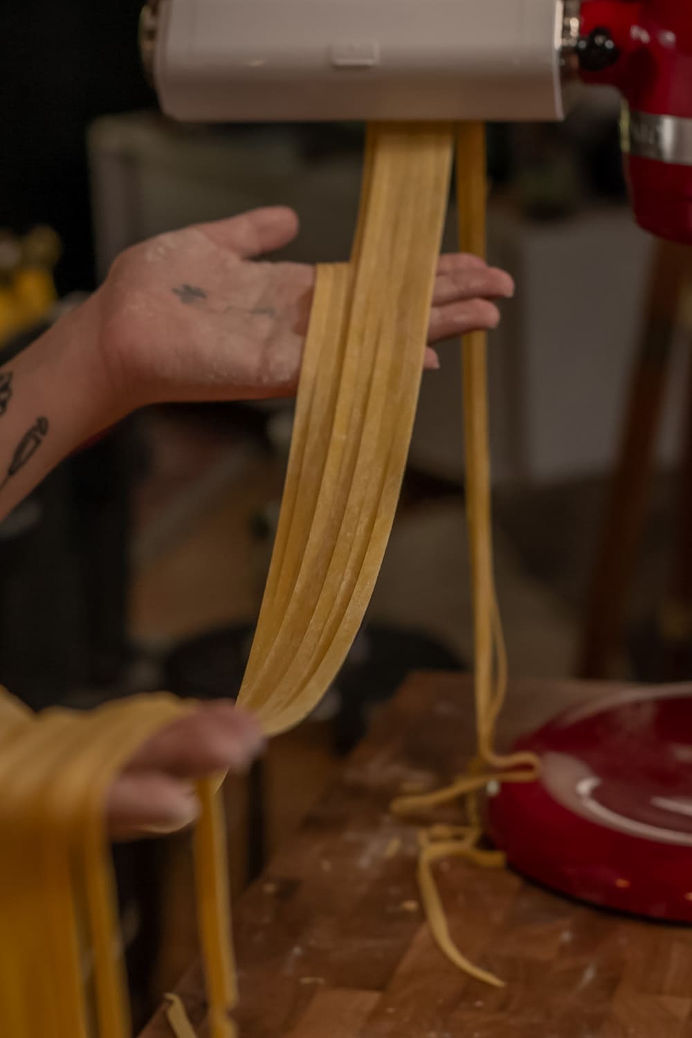 Fresh pasta sheets hanging from the pasta roller